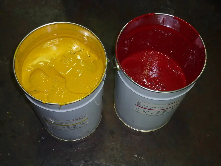Open tins of yellow and magenta offset printing ink